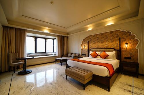 a large bedroom with a large bed and a desk at Sahdev Bagh in Pushkar