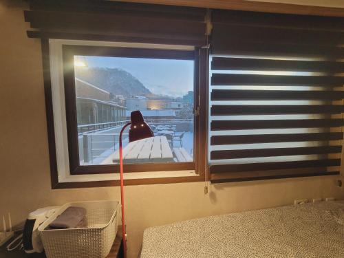 a room with a window with a lamp and a bed at Olive Hostel MyeongDong in Seoul