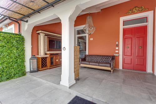a red door on a house with a couch at Casa Gardenia -affittacamere in Gatteo