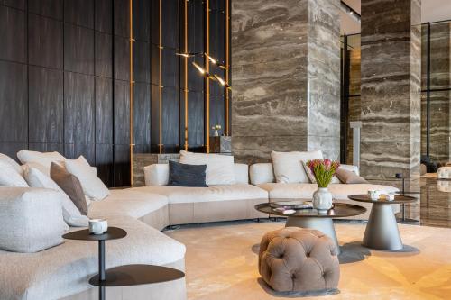 a living room with two couches and two tables at The Icon Limassol in Limassol