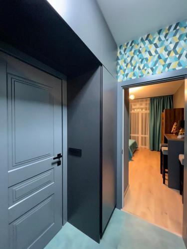 a room with a sliding door and a hallway at Apartments Lux in city center Lviv in Lviv