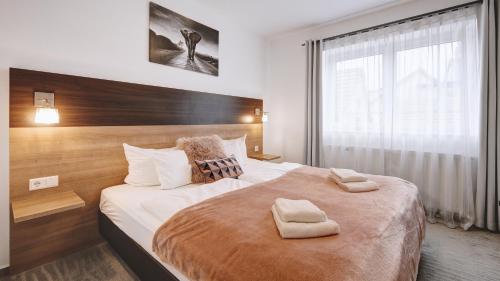 a bedroom with a large bed with two towels on it at Boutique-Hotel Kronenstuben in Ludwigsburg