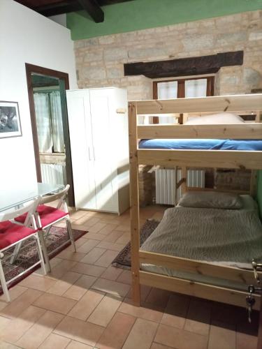 a bedroom with a bunk bed and a table and a desk at San Rocco Affittacamere in San Severino Marche