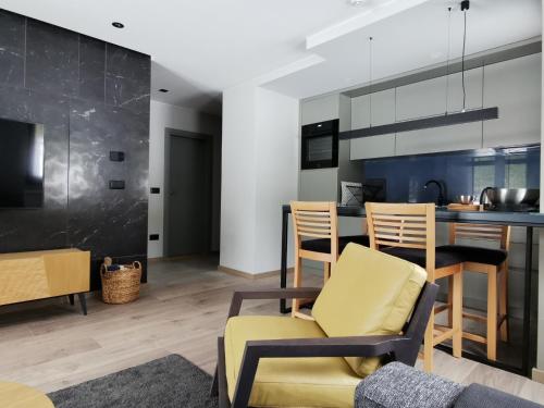 eine Küche und ein Wohnzimmer mit Stühlen und einer Theke in der Unterkunft Vila Nordika Tornik in Tornik