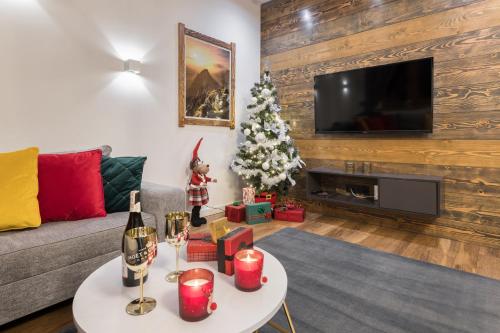 a living room with a christmas tree and a couch at Willa Jarosta in Zakopane