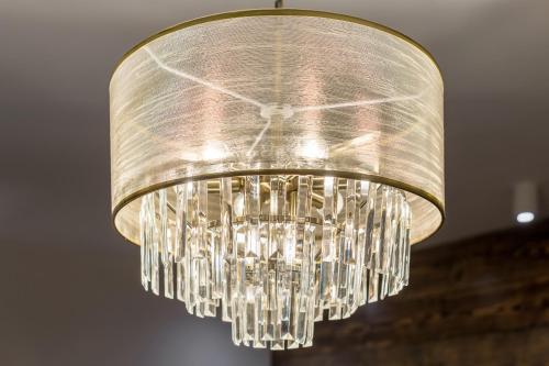 a clear glass chandelier hanging from a ceiling at WILLA JAROSTA & SPA, AC -free parking in Zakopane