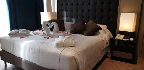 a bedroom with a bed with towels on it at Best Western Plus Hotel Perla Del Porto in Catanzaro Lido
