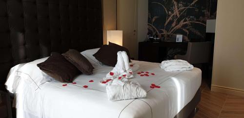 a white bed with towels and flowers on it at Best Western Plus Hotel Perla Del Porto in Catanzaro Lido