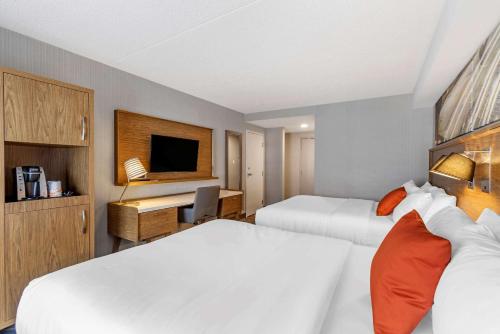 a hotel room with two beds and a television at Comfort Inn in Sarnia
