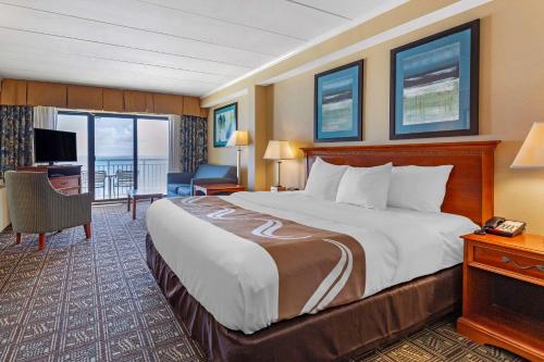 a hotel room with a large bed and a television at Quality Inn Boardwalk in Ocean City
