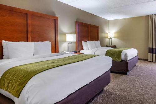a hotel room with two beds and two lamps at Comfort Inn Matthews / Charlotte in Matthews