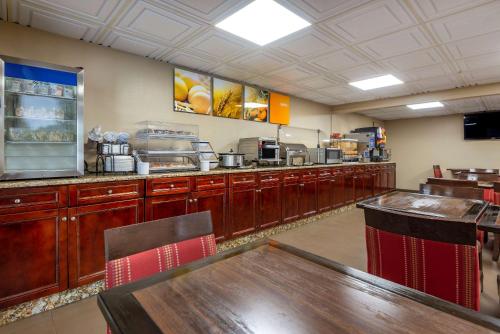 a restaurant kitchen with wooden cabinets and a counter at Comfort Inn Matthews / Charlotte in Matthews