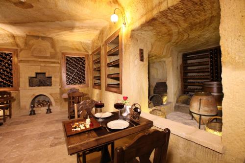 a large room with a table and a wine cellar at Kayakapi Premium Caves Cappadocia in Urgup