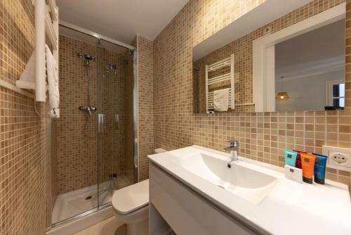 a bathroom with a sink and a shower and a toilet at Bravissimo Barca Studio Dos in Girona