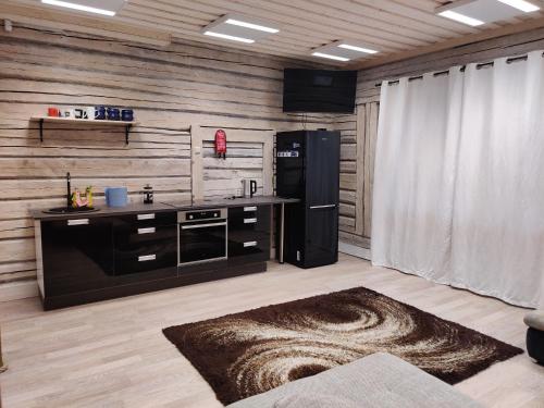 a kitchen with a black refrigerator and a counter at Ökopesa Külaliskorterid in Otepää