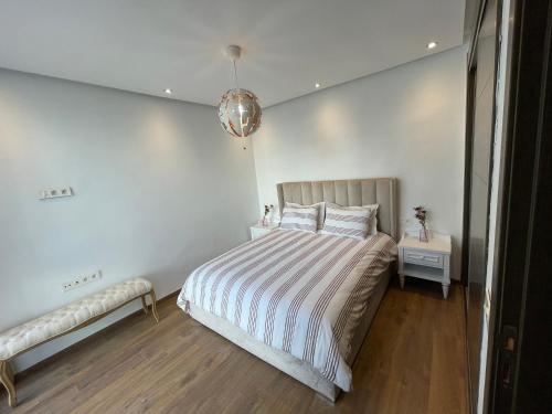 una camera da letto con un letto a righe di AGADIR BAY - LUXURY APARTMENT NEAR BEACH ad Agadir