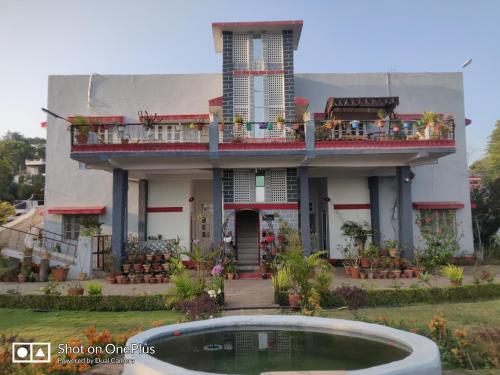 a house with a pool in front of it at Jheelam Homestay in Bhopal
