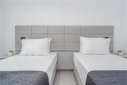 two beds sitting next to each other in a room at Panorama in Laganas