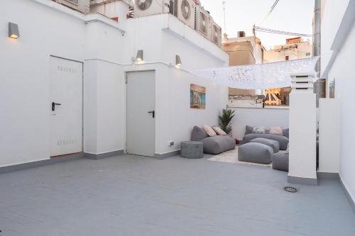 a white room with couches and a building at Moontels Paseo de Ruzafa in Valencia