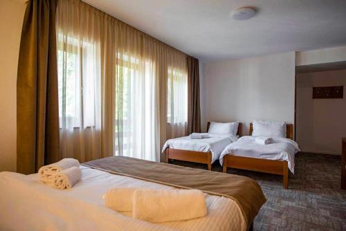 a hotel room with two beds and a window at Hotel Villa Ugar Vlašić in Vlasic