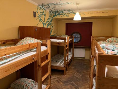 a room with four bunk beds and a mirror at 50 People Bis Apartment in Kraków