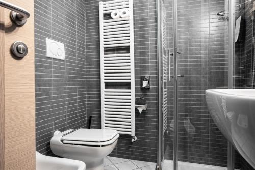 a bathroom with a toilet and a sink and a shower at Hotel Belvedere in Manerba del Garda