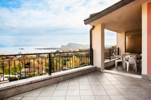 a balcony with a view of the mountains at Hotel Belvedere in Manerba del Garda