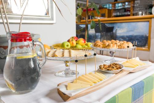 a table with cheese and other foods on a table at Stella Mare Eco Boutique House in Zavala