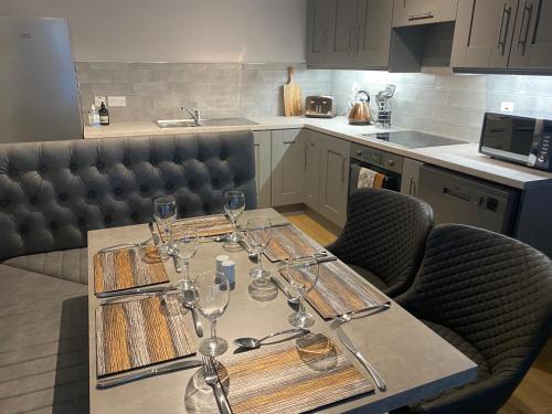 a table with wine glasses on it in a kitchen at Dunlap Apartments in Strabane