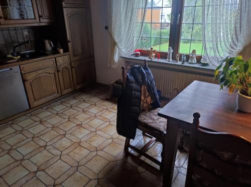 a kitchen with a table and a table and a chair at Wiehenblick in Hüllhorst