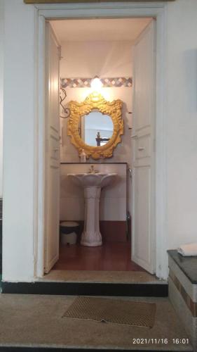 a bathroom with a sink and a mirror at Indeco Hotels Swamimalai in Kumbakonam