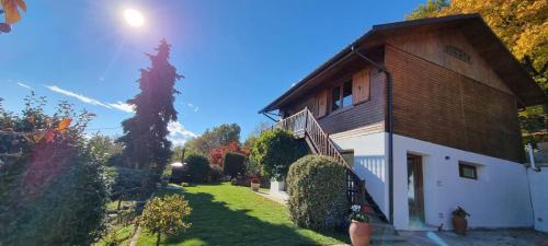 a house with a grass yard next to a building at Chalet Sophie - Luxury Chalet in Roletto