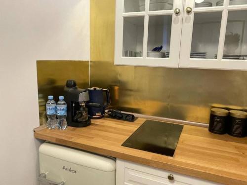 a kitchen counter with bottles of water on it at Willa 1936 , Parking in Toruń
