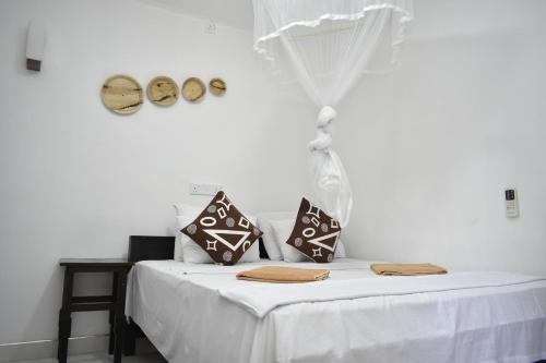 Postel nebo postele na pokoji v ubytování Sigiri Rock Side Home Stay