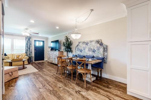 a dining room and living room with a table and chairs at Sapphire in the Sand in Panama City Beach
