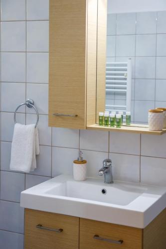 a bathroom with a white sink and a mirror at 4 Seasons villa-Sea view in Hersonissos