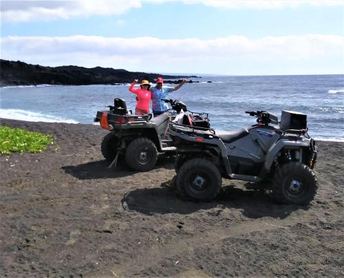 a group of people standing on a beach with atvs at Ocean View Paradise! in Hawaiian Ocean View