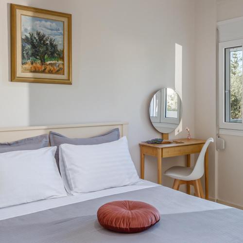 a bedroom with a bed with a red pillow on it at 4 Seasons villa-Sea view in Hersonissos