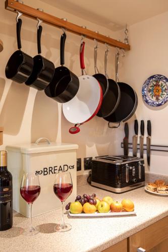 a kitchen counter with two glasses of red wine at Ingleton - 2 Bed Cottage - Sleeps 4 - Pet Friendly in Carnforth