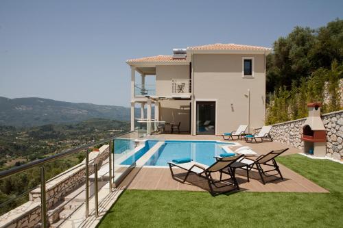 a villa with a swimming pool and a house at Heavenly Heights Villas in Évyiros