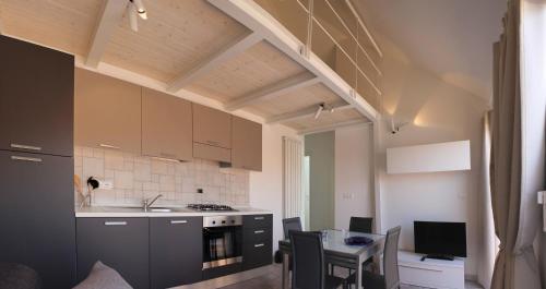 a kitchen and dining room with a table and chairs at Residenza Nam in Alassio