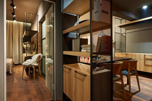 a small apartment with a room with a desk and a kitchen at Premium Luxury SeaSide Apartment in Burgas City