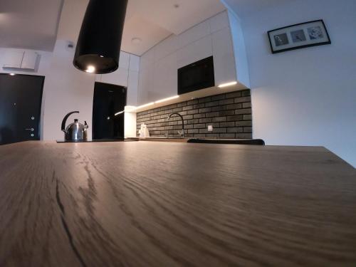 a kitchen with a wooden counter top in a room at Apartment 2-Rooms-Garage-TV-Wifi in Poznań