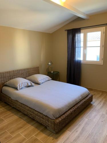 En eller flere senge i et værelse på Appartement, centre ville AIGUILLON