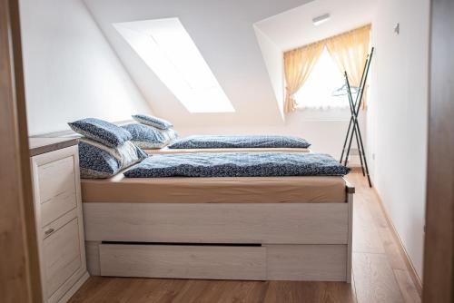 a bed in a room with a window at Apartment Sebiell in Vrchlabí