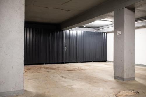 an empty room with a black wall and two columns at Apartment Sebiell in Vrchlabí