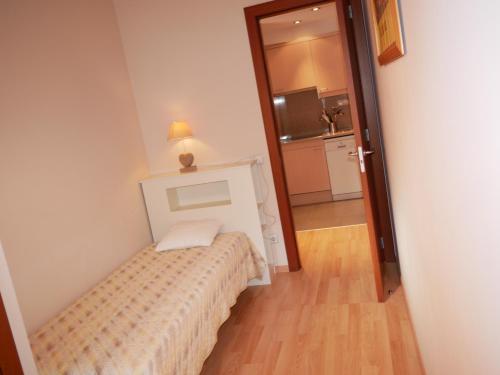 a small bedroom with a bed in a room at Solana-El Tarter in El Tarter