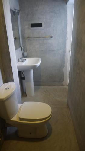 a bathroom with a toilet and a sink at The Reef Weligama in Weligama