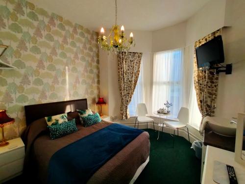 a bedroom with a bed and a sink in it at Hotel Babylon in Blackpool
