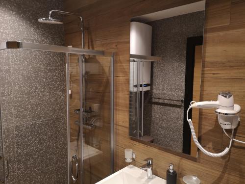 a bathroom with a shower and a sink and a mirror at MM Kolasin Lux N1 in Kolašin